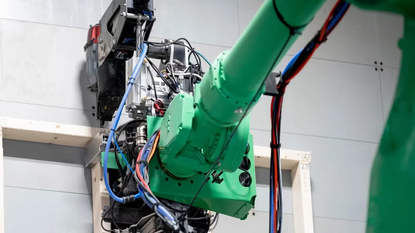 Robotic arm framing a wall panel in a Reframe Systems microfactory